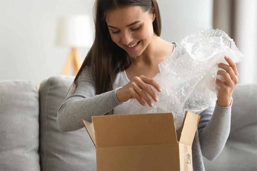 woman opening box of aroma products